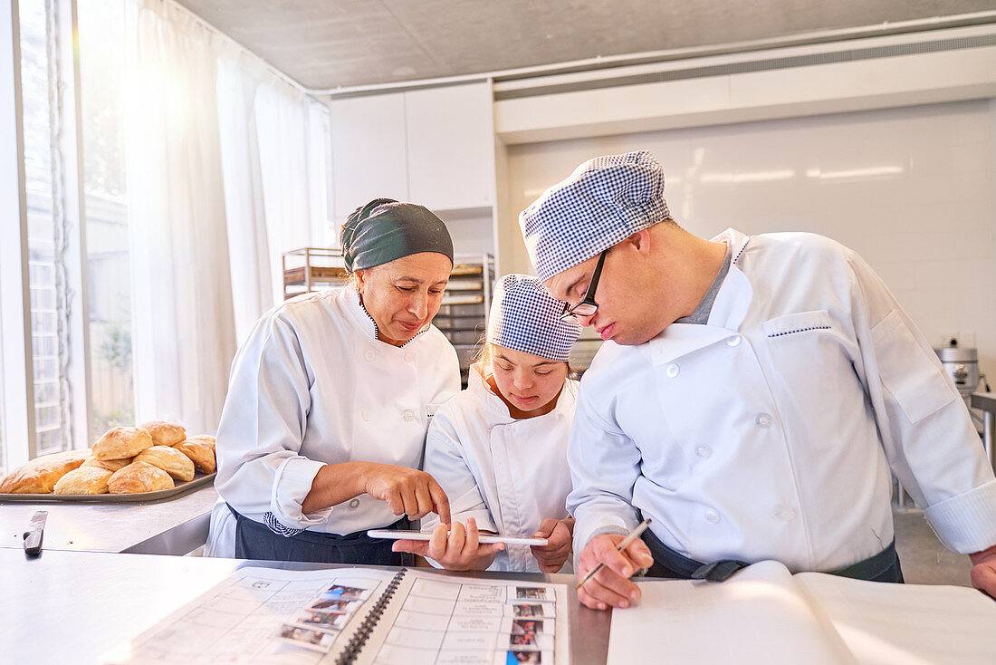 Chef and students with Down Syndrome using tablet