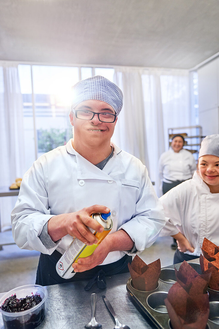 Portrait male student with Down Syndrome in baking class