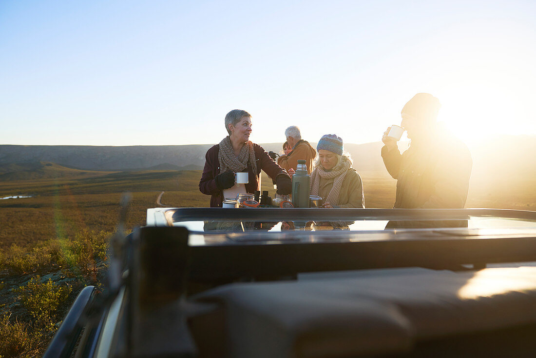 Safari tour group drinking tea at sunrise South Africa
