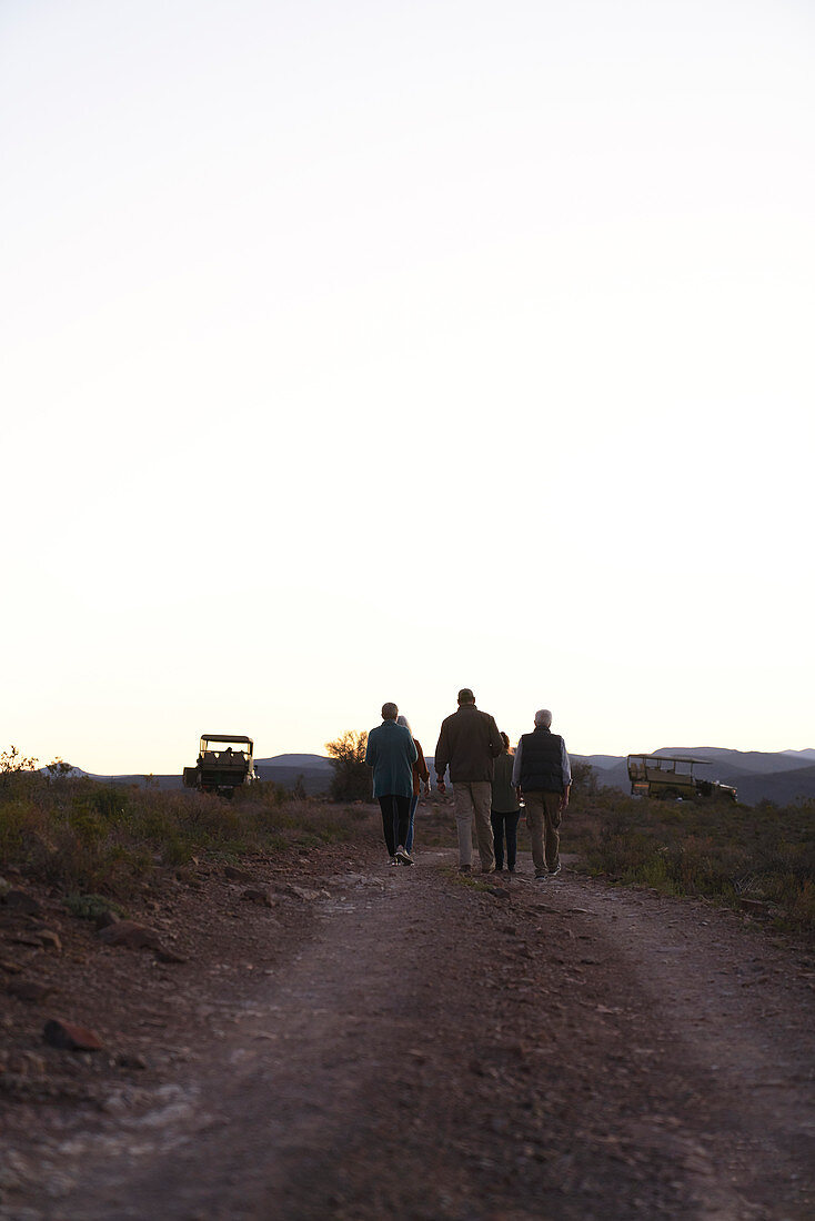 Safari tour group walking along dirt road