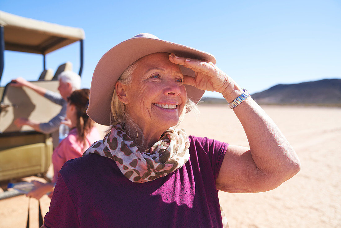 Portrait happy senior woman on safari