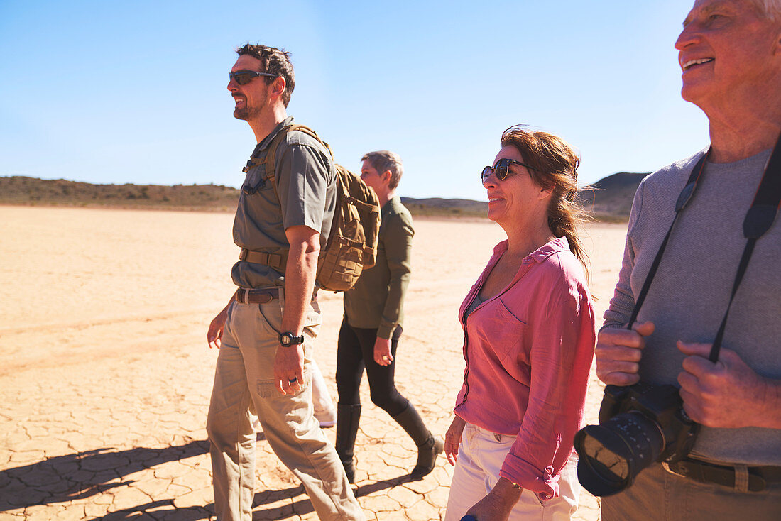Guide and group walking in arid desert South Africa