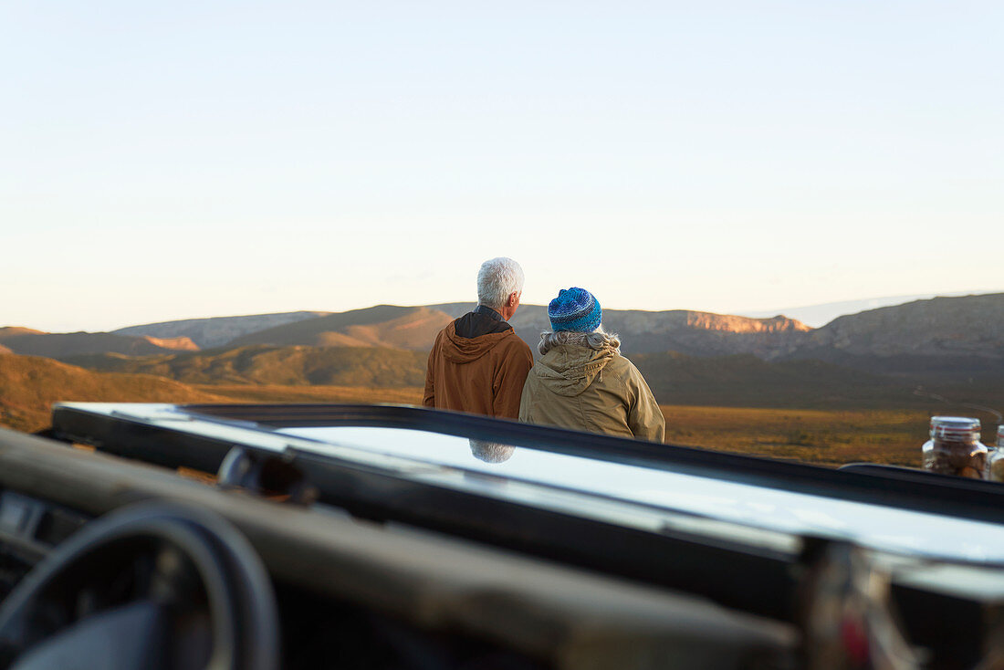 Senior couple on safari looking at scenic landscape view