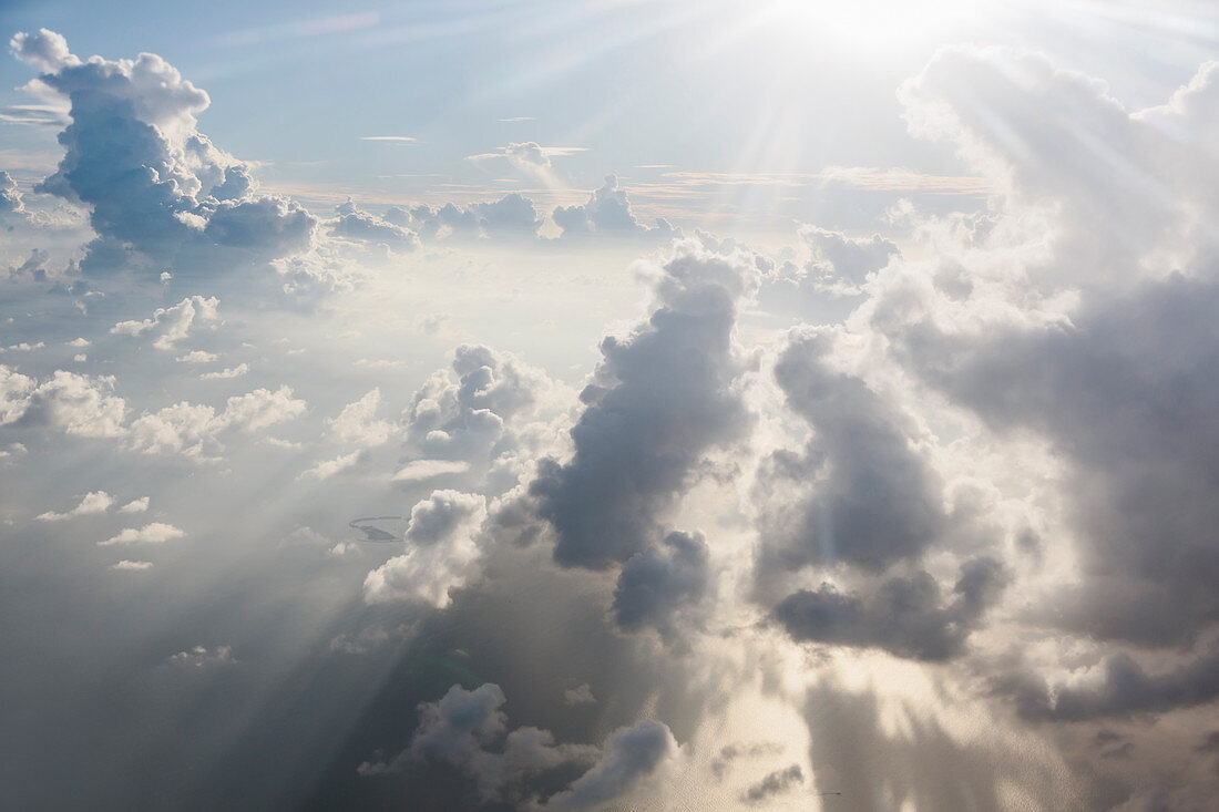 Aerial view sunbeams and fluffy white clouds
