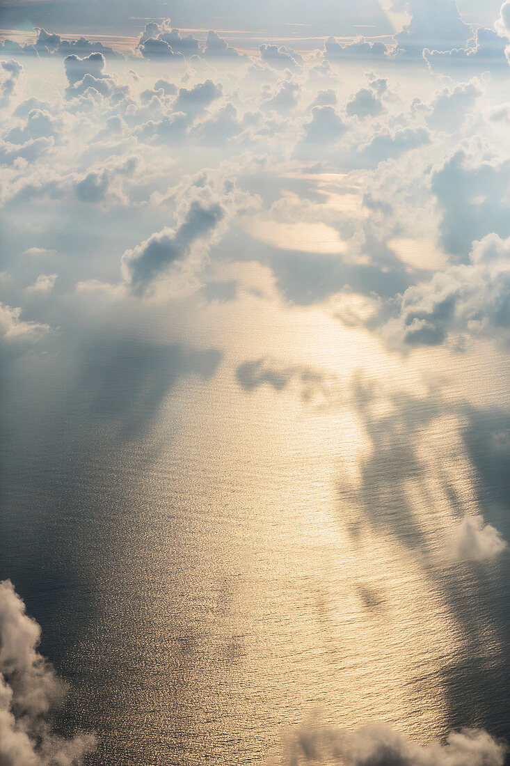Aerial view clouds over sunny, tranquil ocean, Maldives