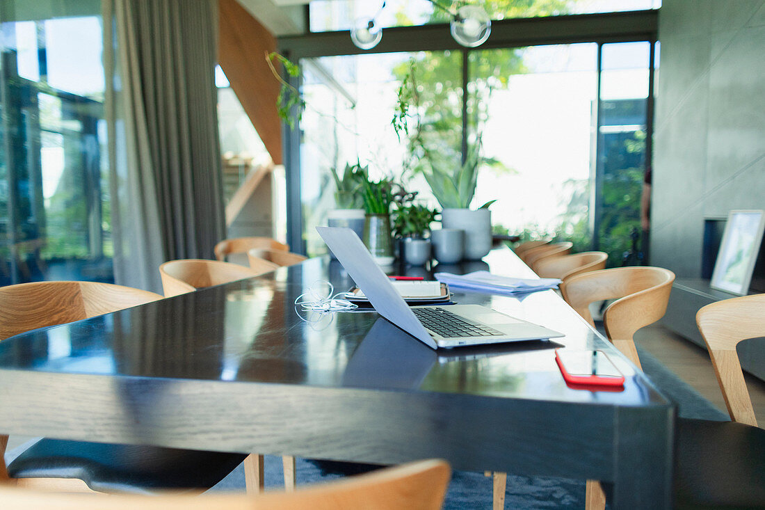 Working from home, laptop and smart phone on dining table