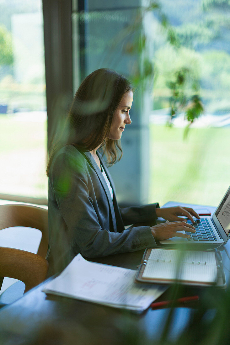 Focused businesswoman working at laptop