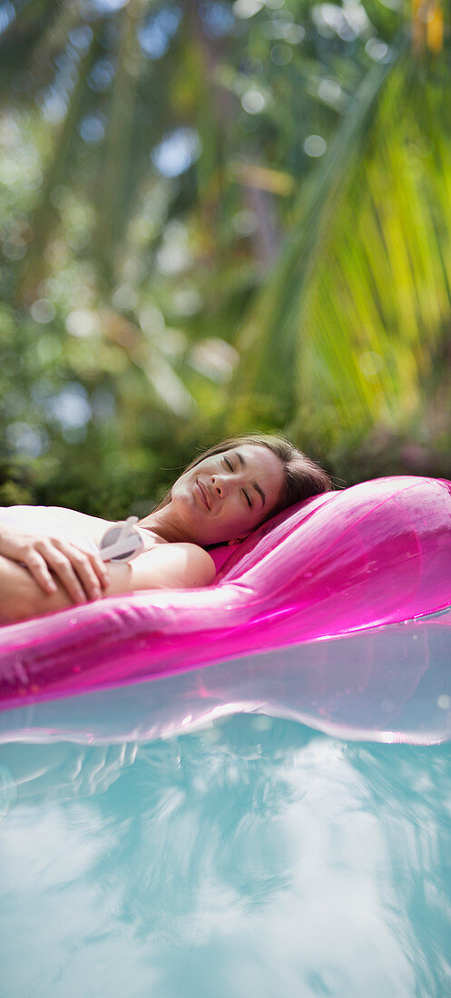Woman relaxing, sleeping on inflatable raft