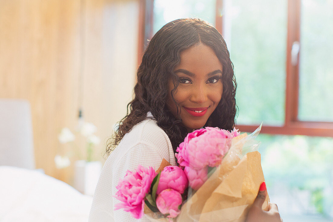 Portrait woman with bouquet of pink peony flowers