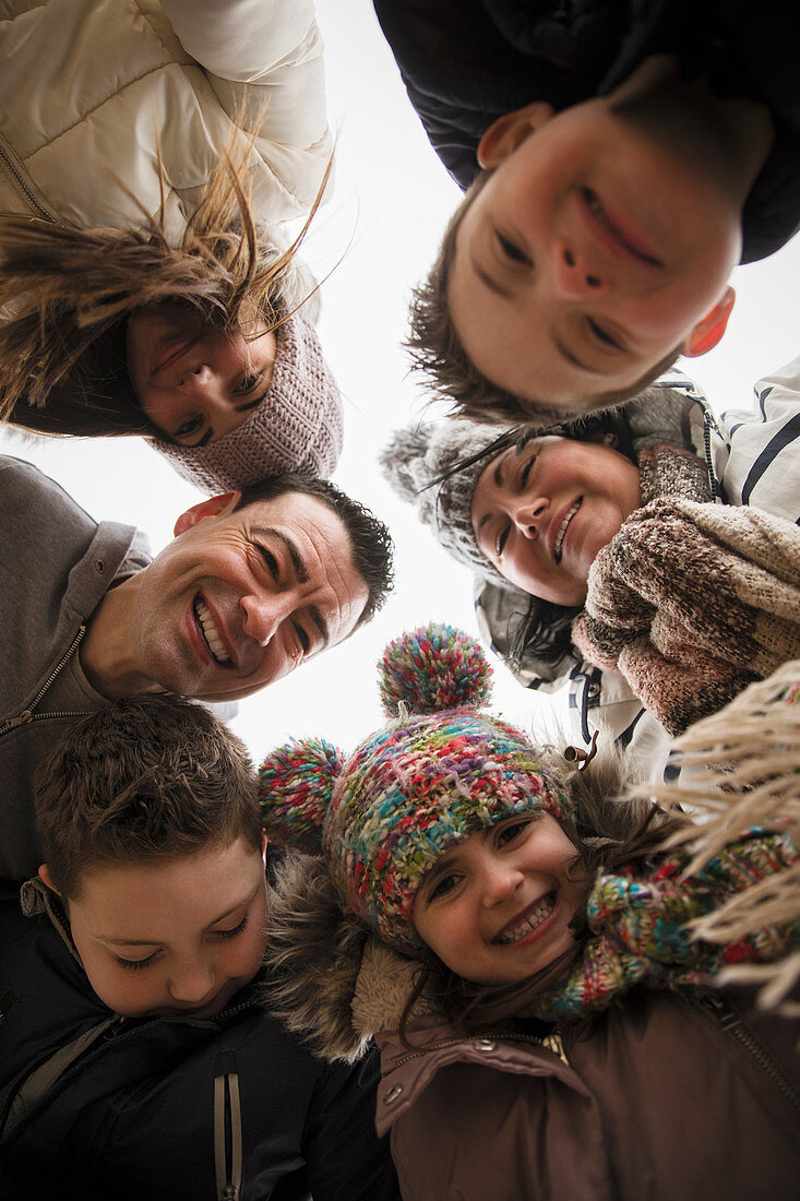 Portrait happy family with Down Syndrome kids in huddle