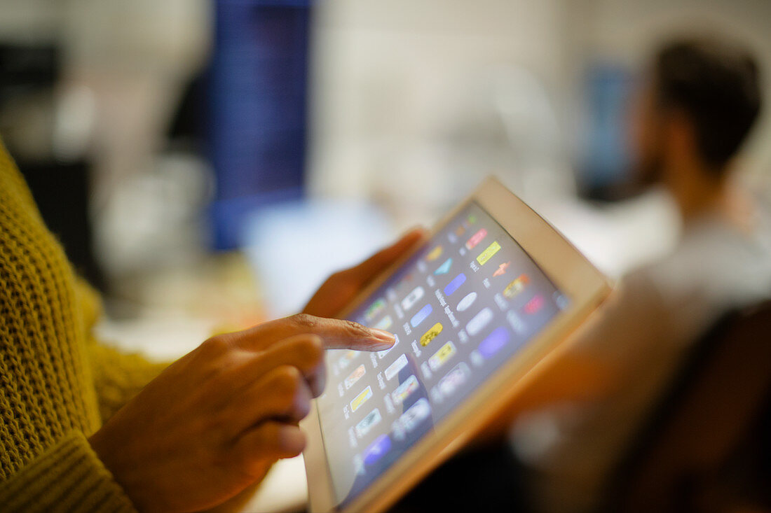 Close up woman using digital tablet touch screen