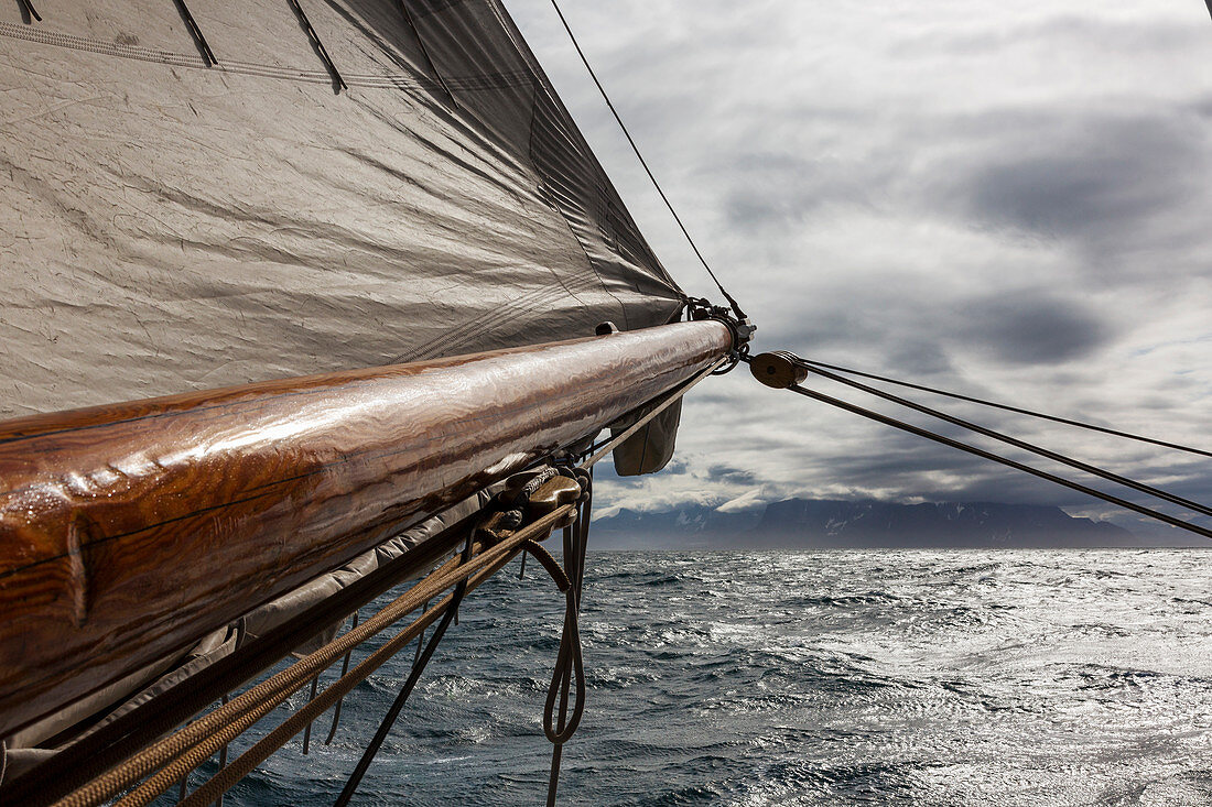 Wooden ship mast and sail over Atlantic Ocean