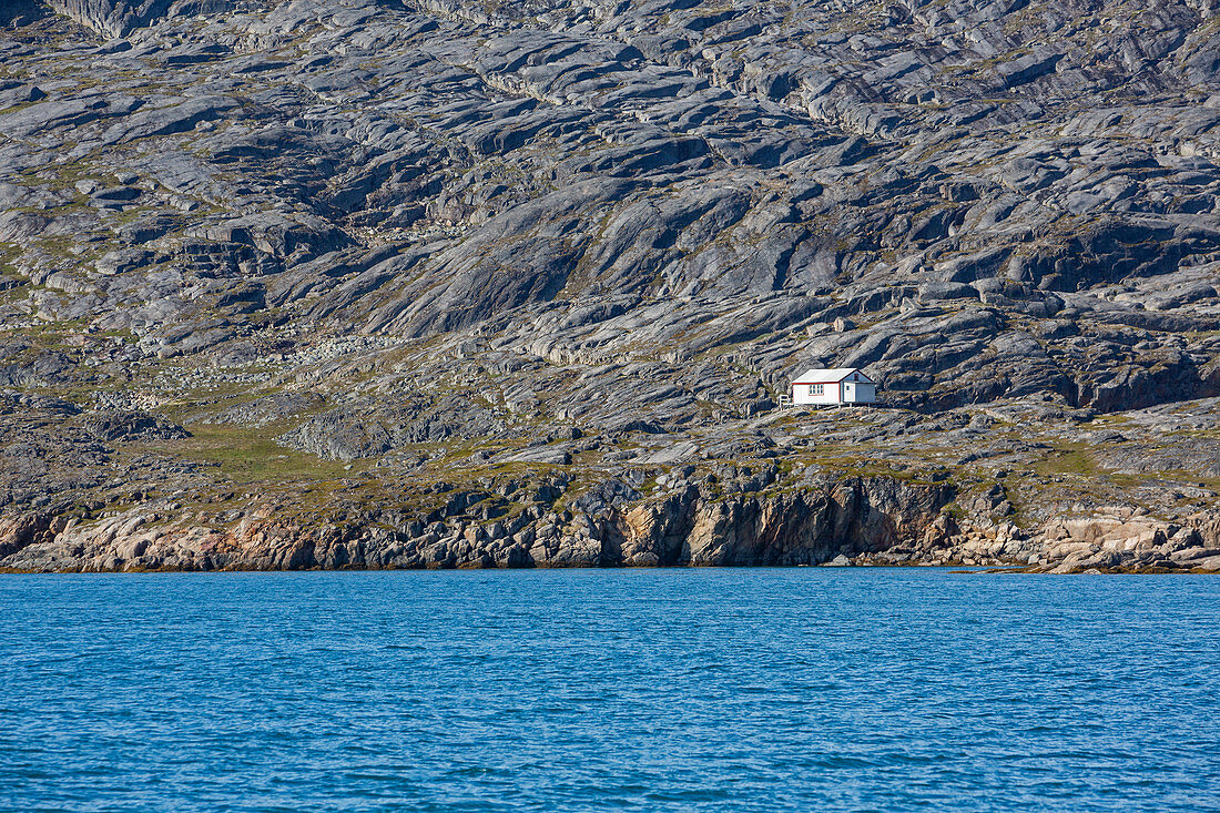 House on rugged remote coastline Disko Bay West Greenland
