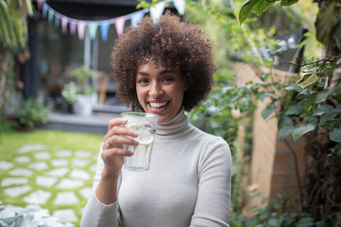 Woman drinking water on patio