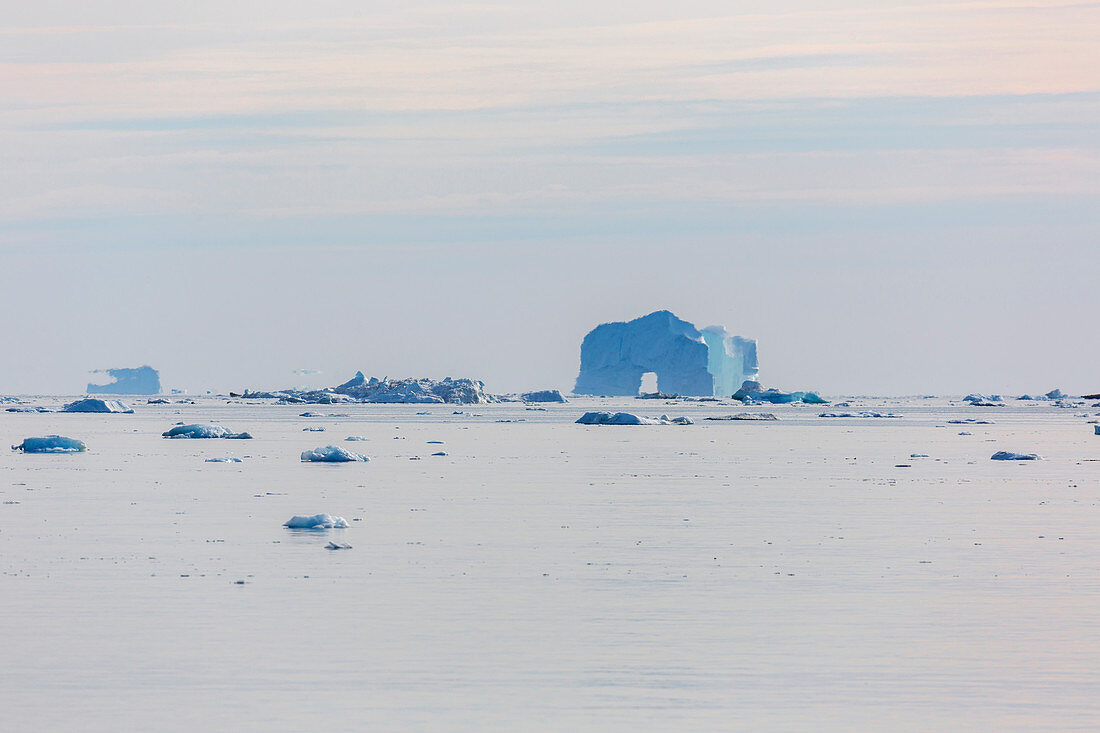 Majestic iceberg arch in distant on tranquil