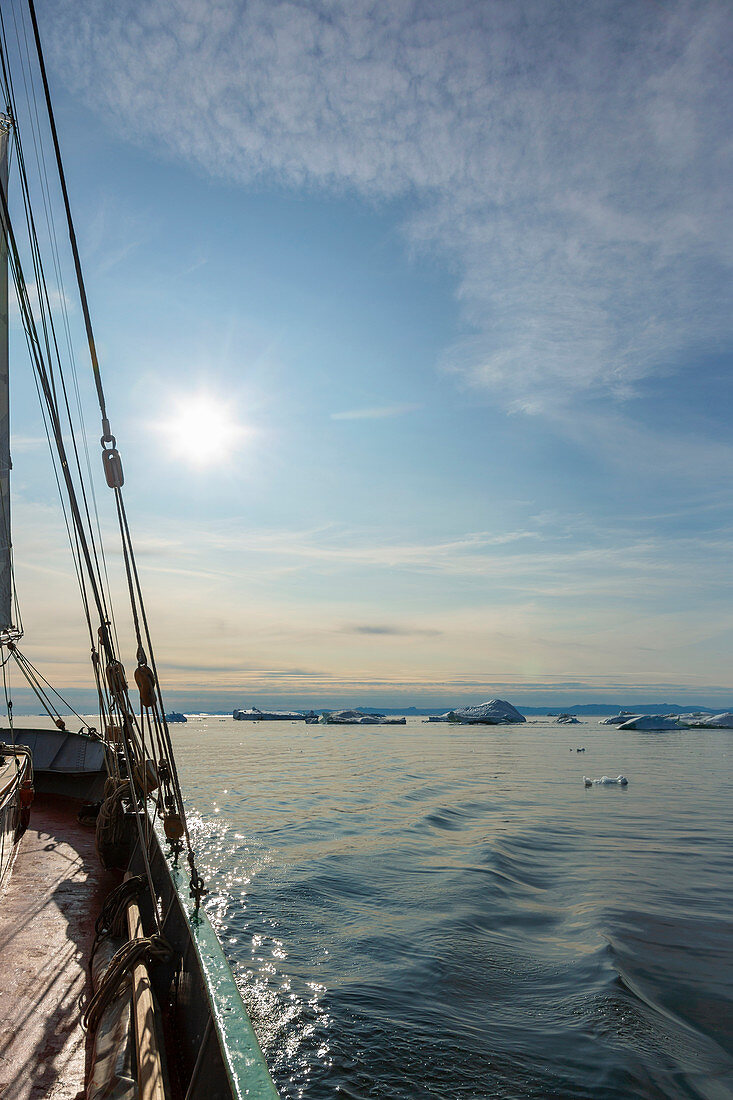 Ship sailing toward icebergs on Atlantic Ocean Greenland