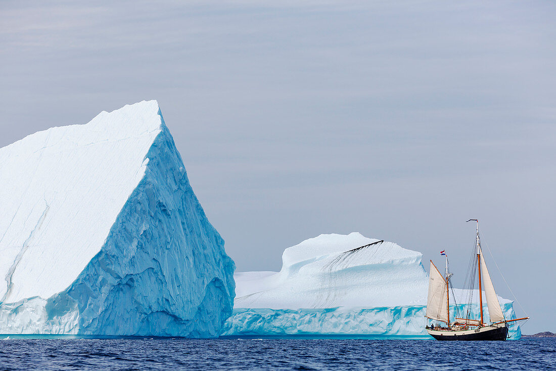 Ship sailing past majestic icebergs on