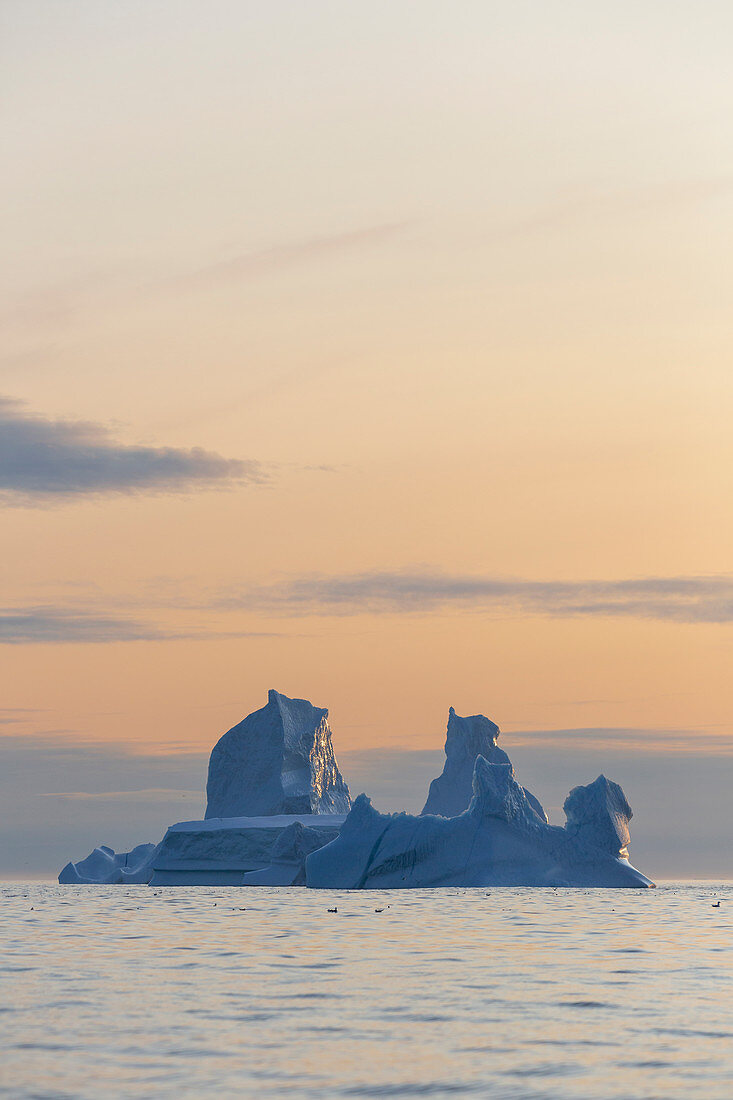 Majestic iceberg formation over sunset