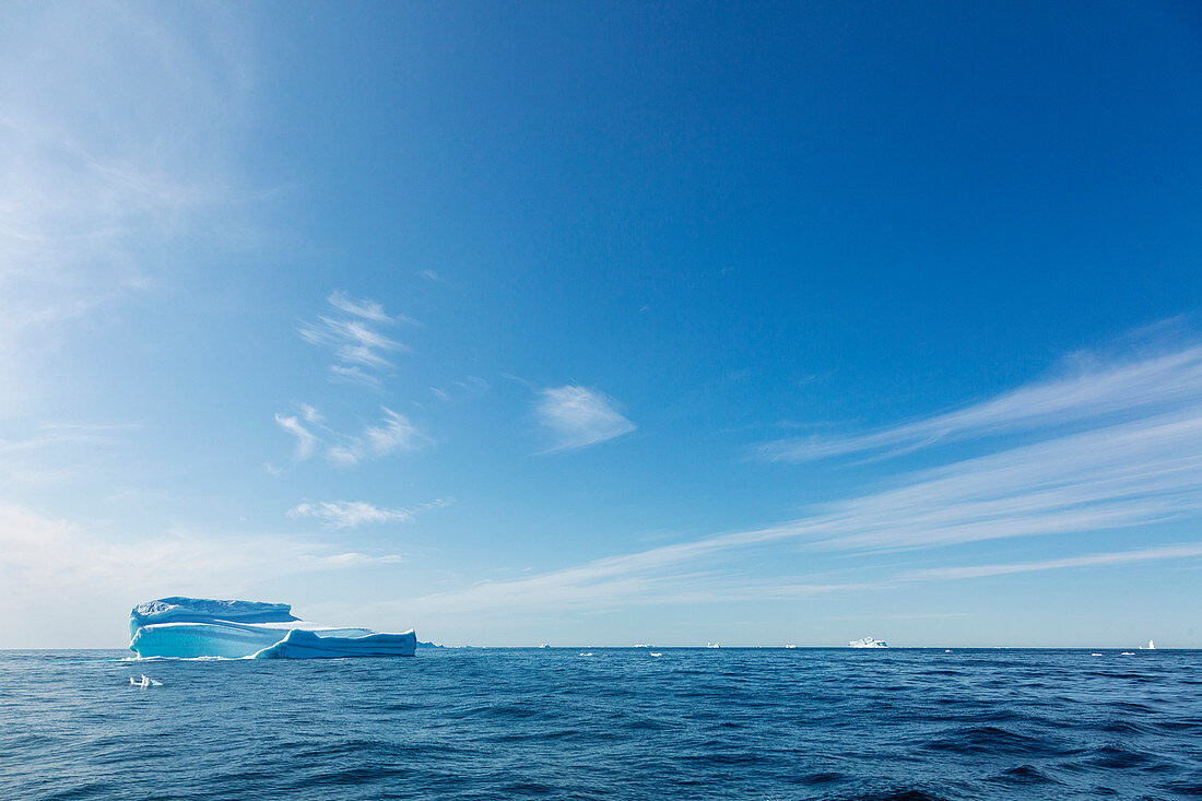 Sunny blue sky over iceberg and Atlantic Ocean Greenland