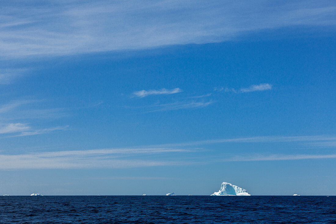 Icebergs in distance on vast blue Atlantic Ocean Greenland