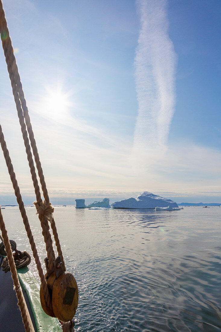 View of icebergs from sailboat on Atlantic Ocean Greenland