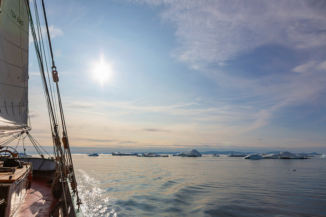 Ship sailing toward melting ice on tranquil