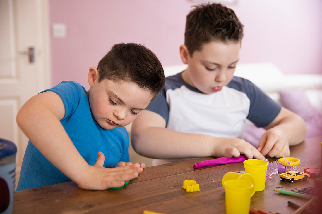 Boy with Down Syndrome and brother playing