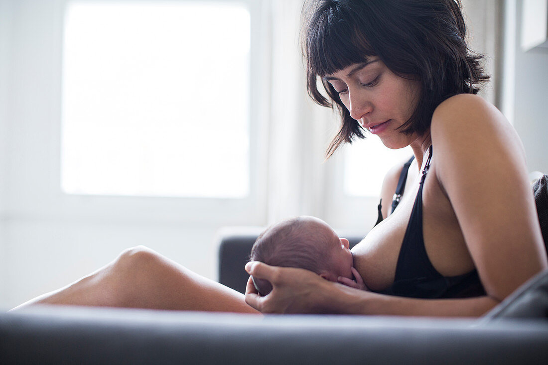 Mother breastfeeding newborn baby son