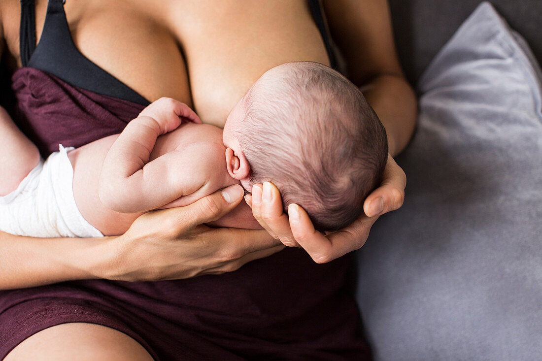 Close up mother breastfeeding newborn baby son