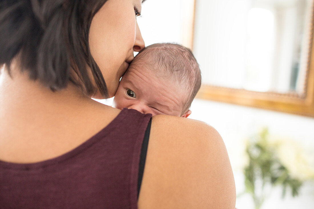 Mother holding newborn baby son