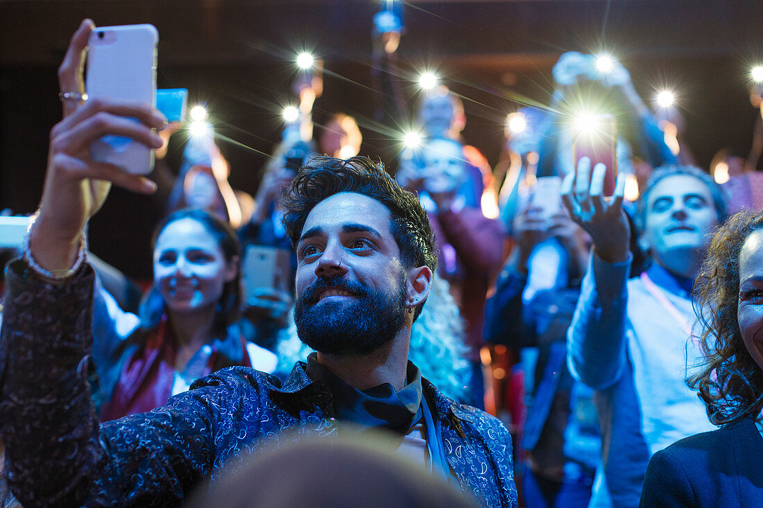 Audience using smart phone flashlights