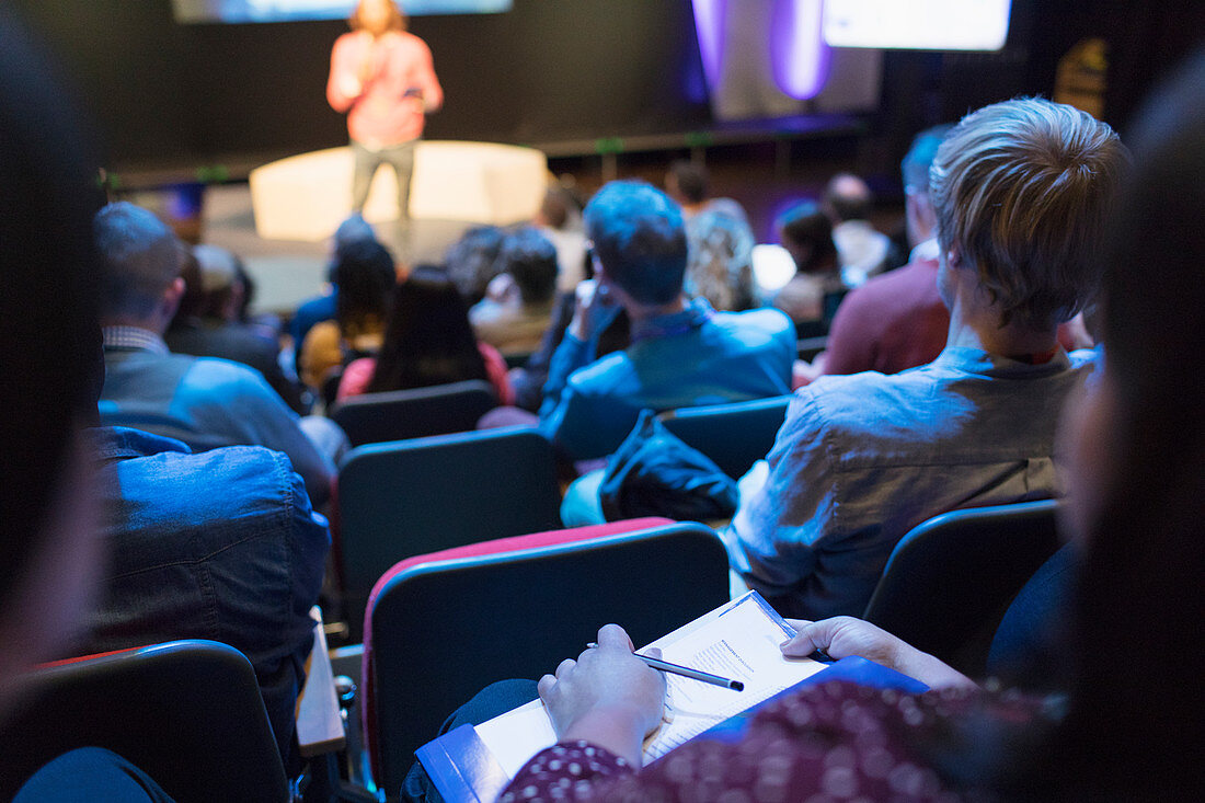 Audience watching speaker on stage