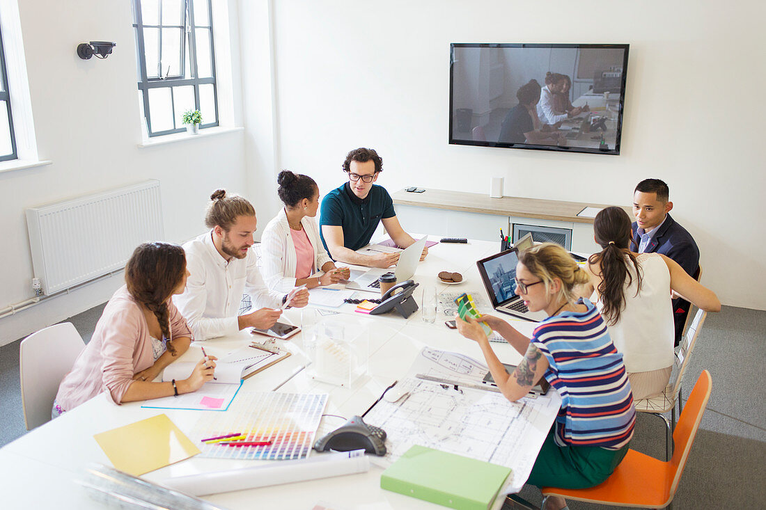 Designers and architects in conference room meeting