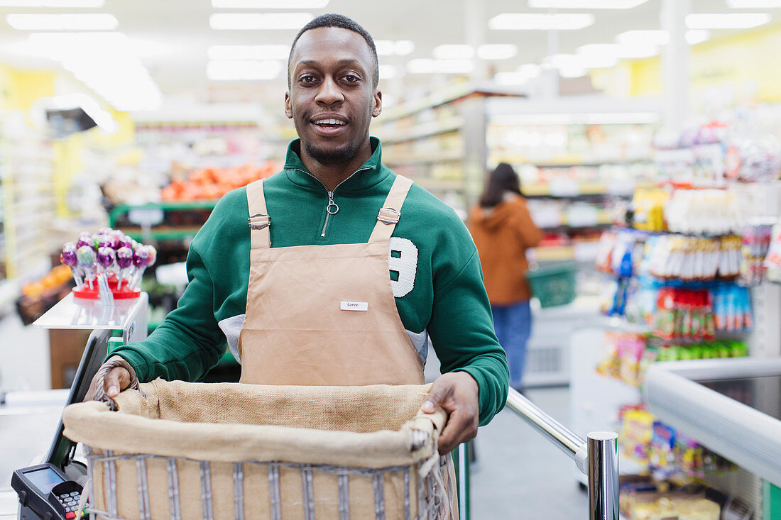 Portrait confident male grocer working in supermarket