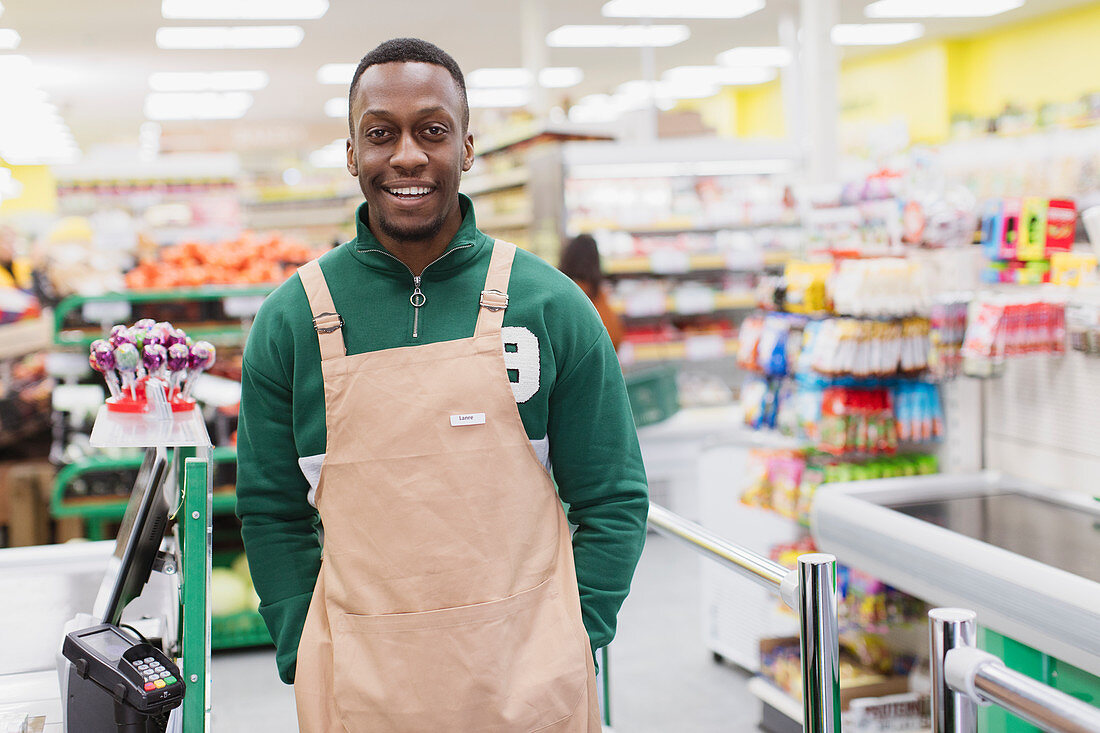Confident male grocer working in supermarket