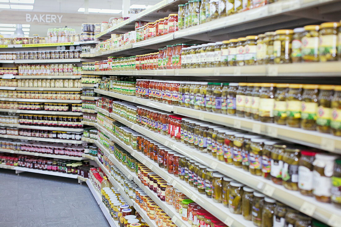 Jars of food lining shelves in supermarket