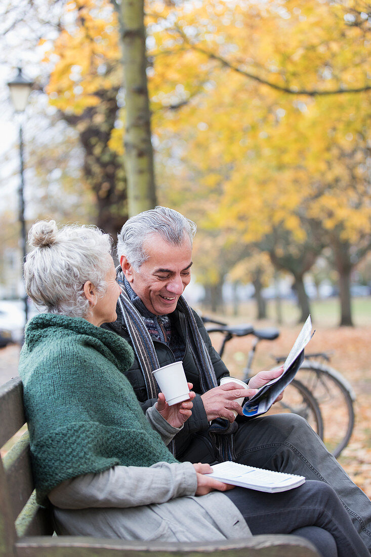 Senior couple reading newspaper and drinking coffee