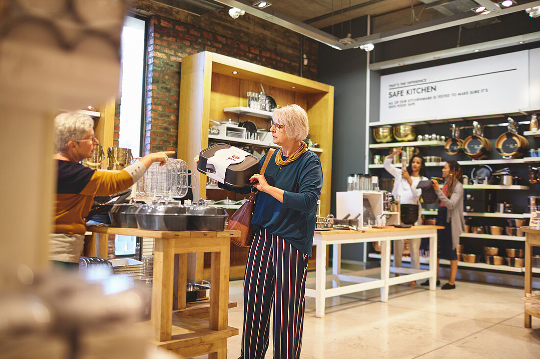 Senior women shopping for bakeware in home goods store
