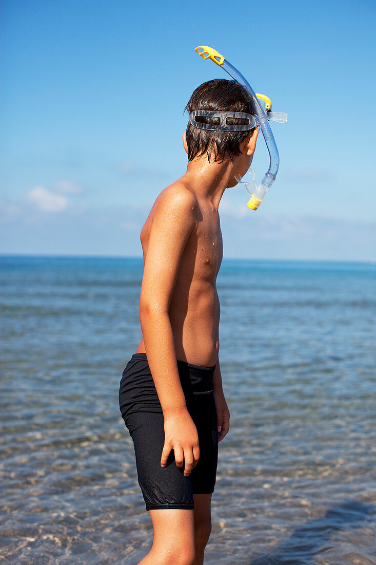 Boy wearing snorkel on beach