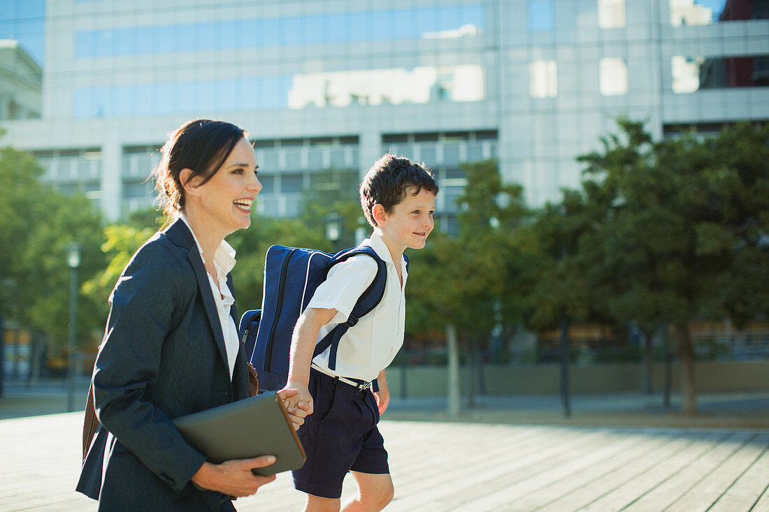 Businesswoman and son outside urban building