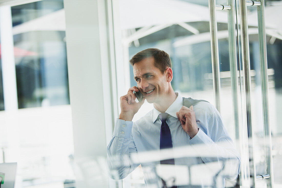 Businessman talking on cell phone in office