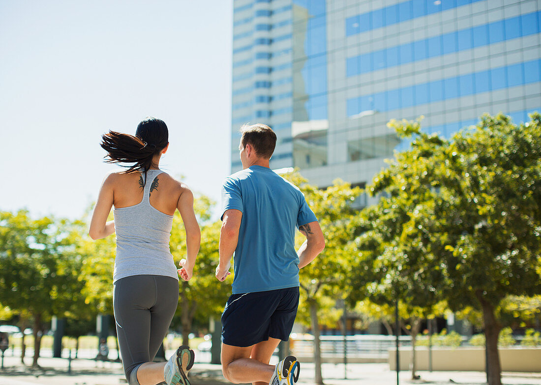 Couple jogging in urban park