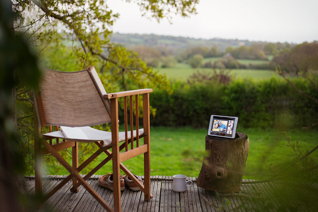 Friends video chatting on tablet screen on idyllic patio
