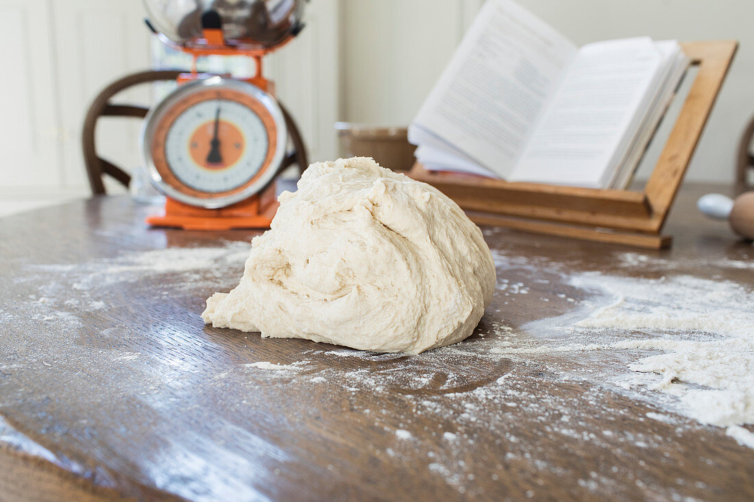 Dough on floured surface in kitchen
