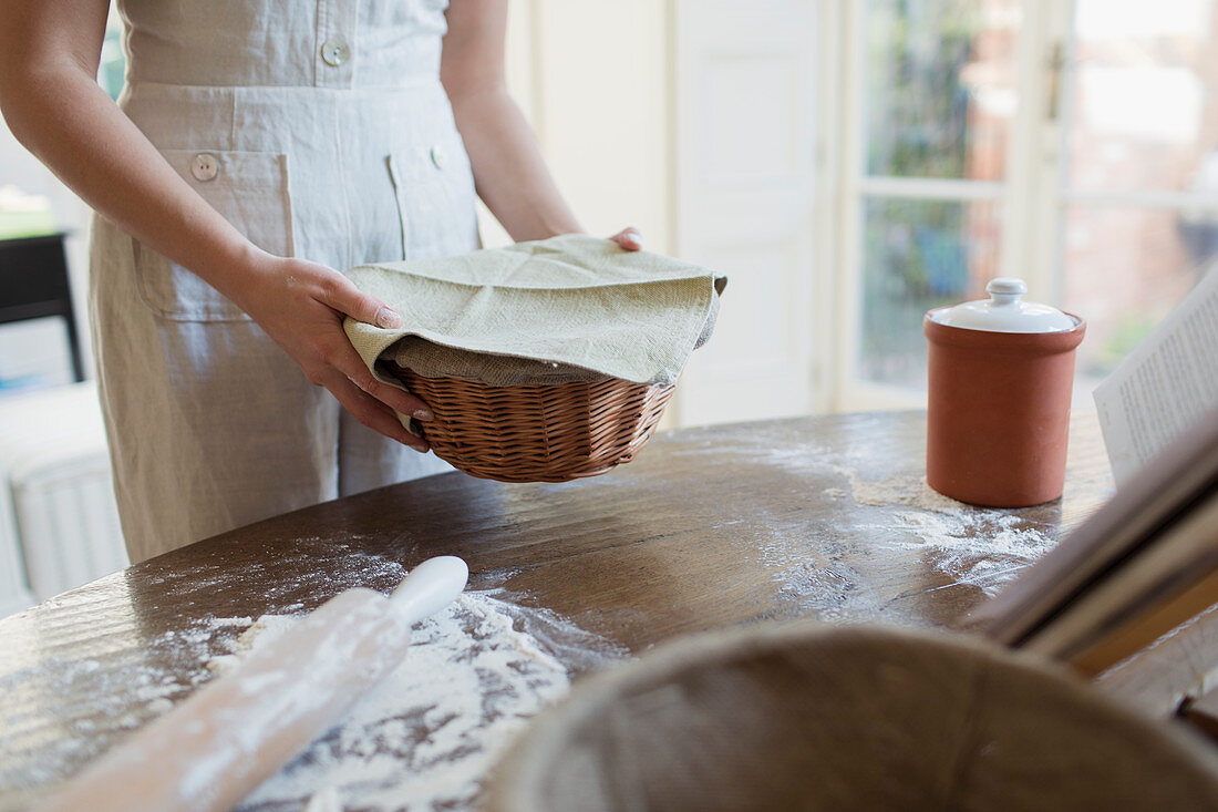 Teenage girl proofing dough in basket