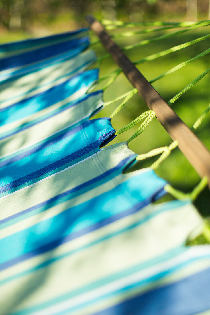 Close up sunshine over blue striped hammock
