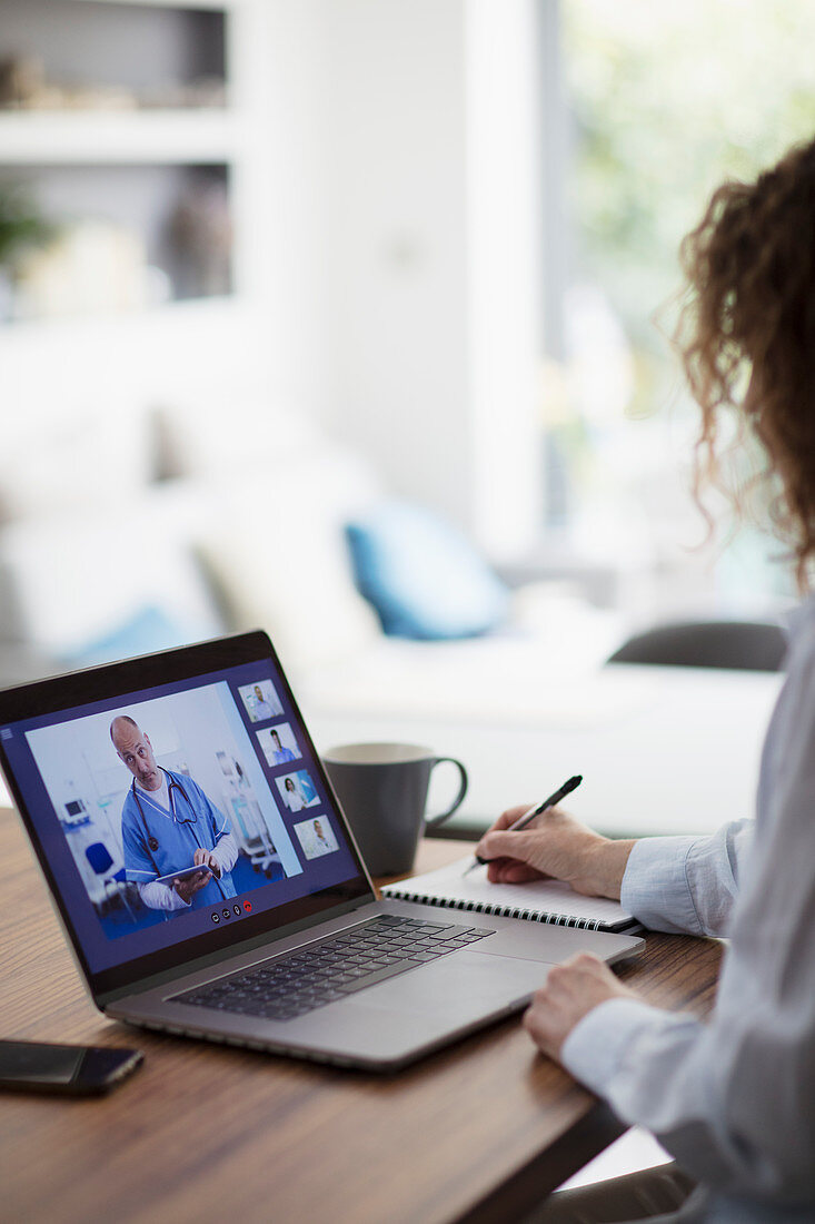 Woman video conferencing with doctor on laptop screen