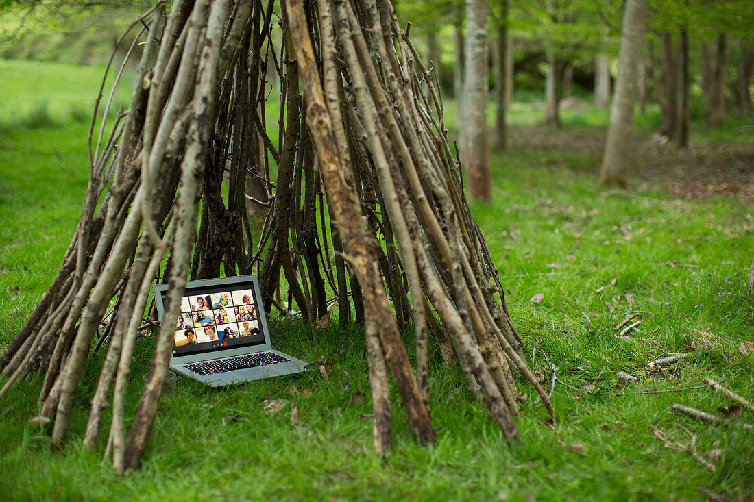Video conference on laptop screen in branch teepee