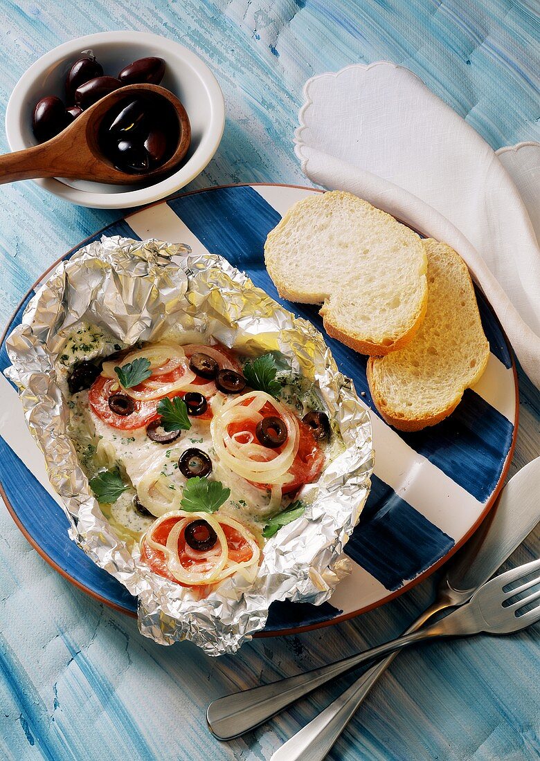 Coley with tomatoes, onions, olives baked in foil