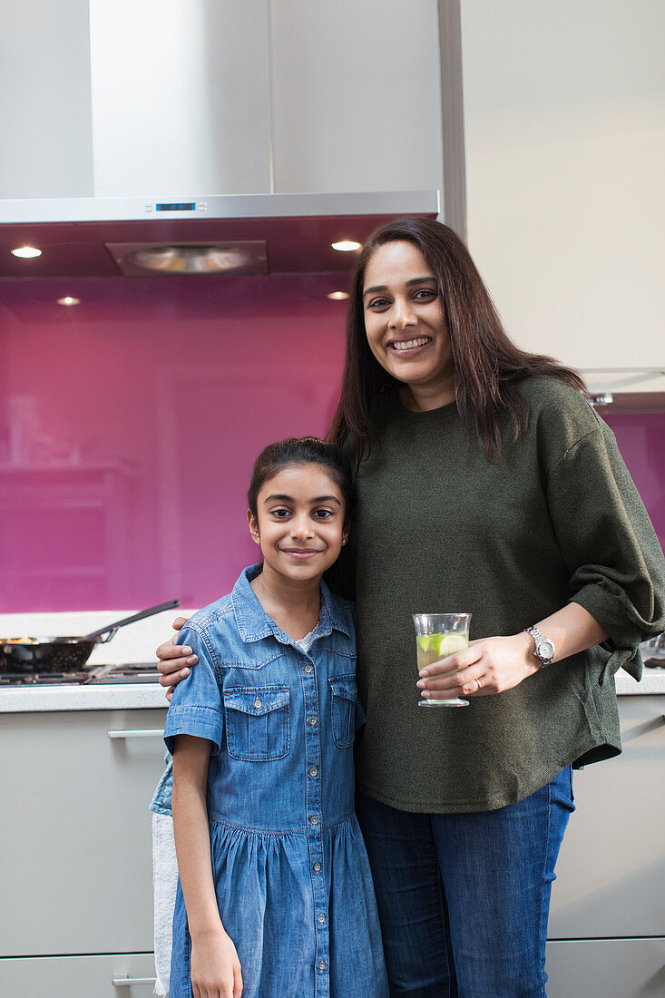 Portrait happy mother and daughter in kitchen